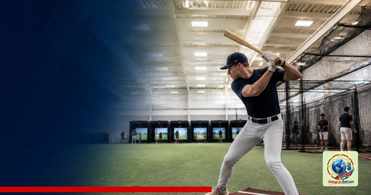 A single athlete trains indoors in a spacious university facility with turf, batting cages, and golf simulators; ample left-s